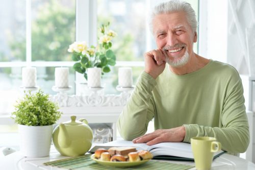 Man smiling while he gets ready to eat